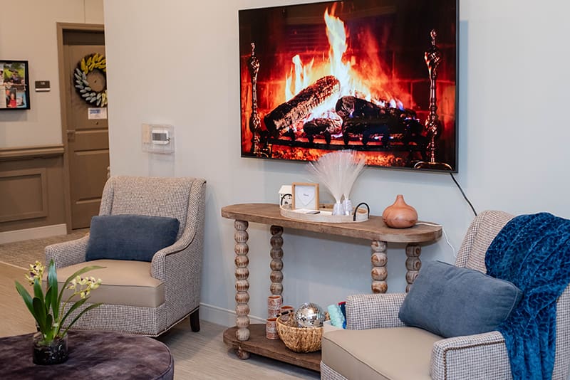 seating area with arm chairs and television